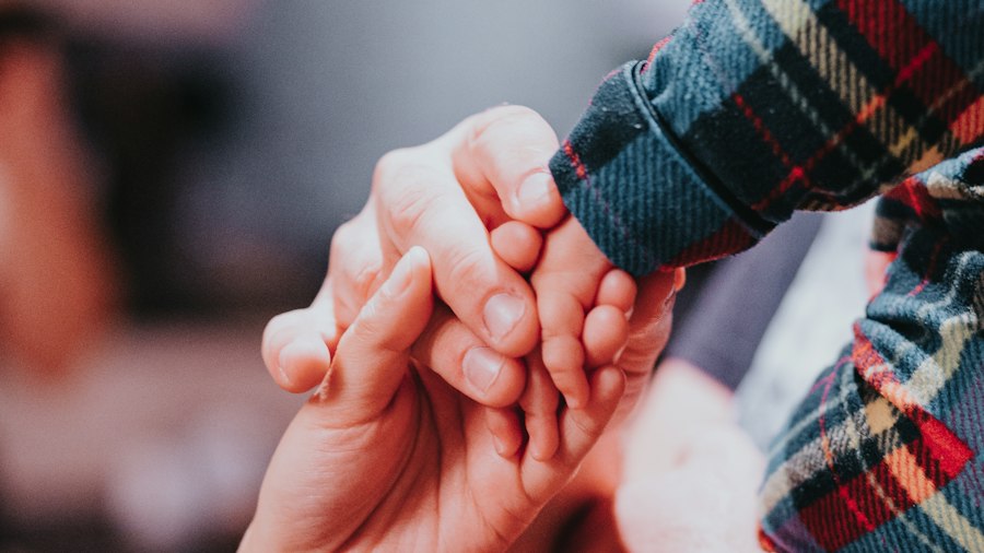 Adult and child holding hands
