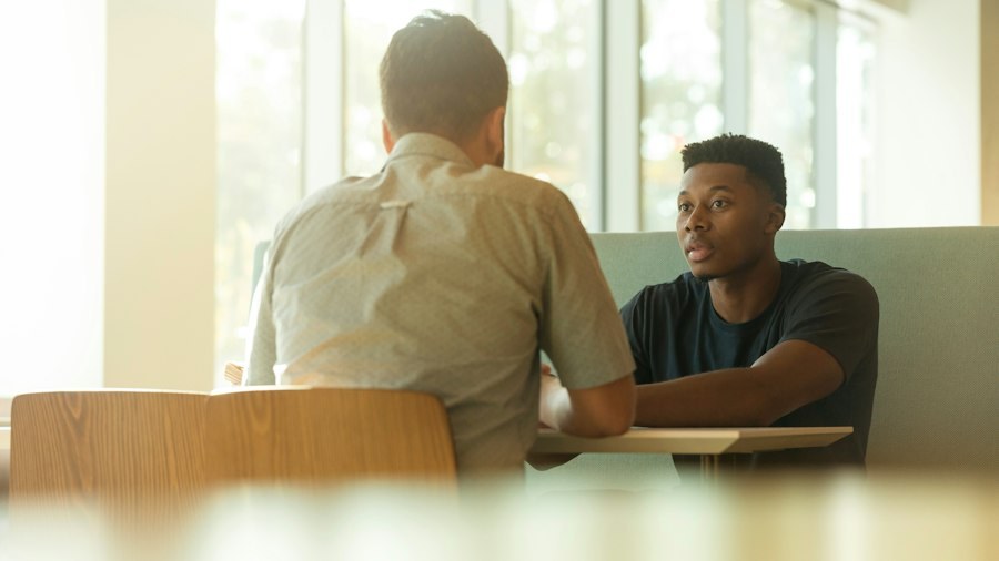 Two people listening and talking across a table