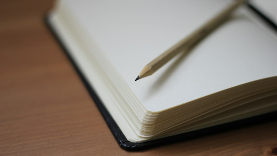 Pencil resting on an open notebook